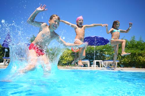 Kinderen springen van de rand van een zwembad