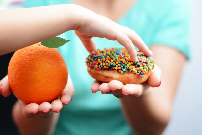Child chooses donut over orange